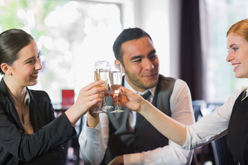 Happy business partners celebrating with champagne