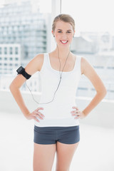 Cheerful fit woman listening to music