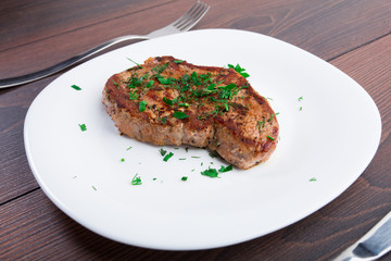 Grilled steak on white plate