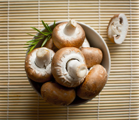 Brown champignon mushroom and rosemary leaves