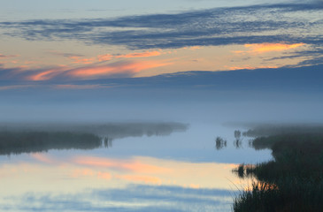 Obraz na płótnie Canvas River at foggy sunrise