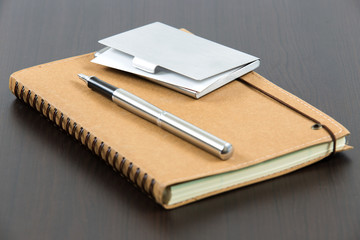 notebook and business card on table