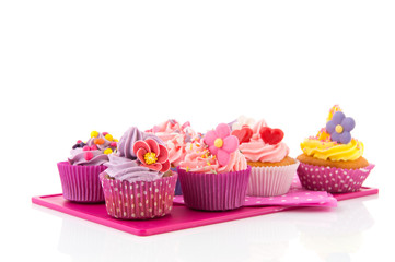 Colorful cupcakes on tray