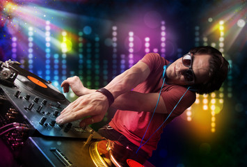 Dj playing songs in a disco with light show
