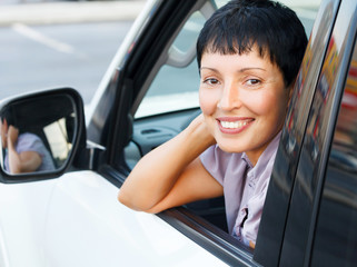 Smiling senior woman in a car