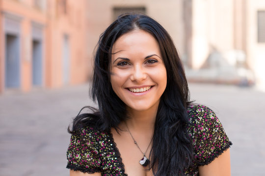 smiling portrait of young woman in the old town