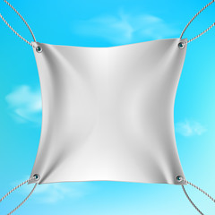 White banner stretched out on the ropes against the blue sky