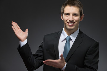 Half-length portrait of business man pointing at something