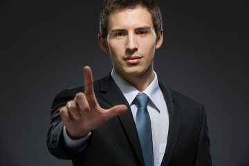 Half-length portrait of business man forefinger gesturing