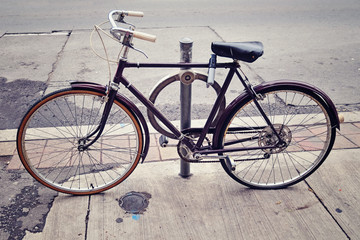 Fototapeta na wymiar An old bicycle locked up on the street in Toronto