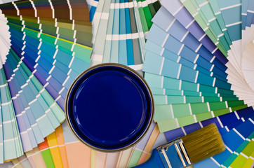 Samples with different shades of blue and a can paint with brush
