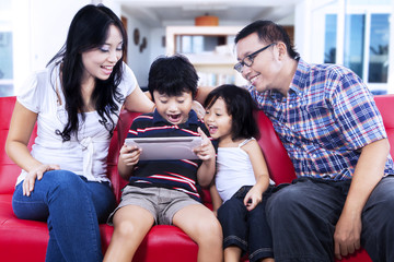 Obraz premium Family using digital tablet browsing the internet