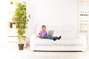 Preschool kid with laptop at home