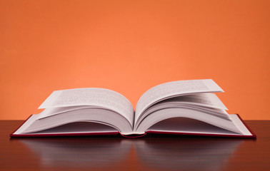 open book on wooden table
