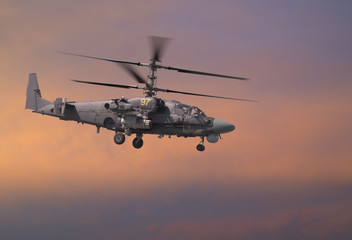 Fototapeta na wymiar Attack helicopter in red sky