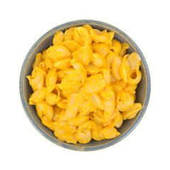 Cheesy pasta shells in bowl on white background