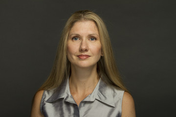 Woman smiling against black background, horizontal