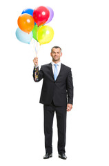 Full-length portrait of businessman with colourful balloons