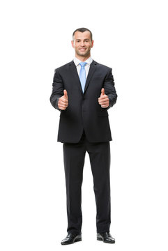 Full-length portrait of businessman who thumbs up