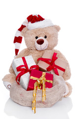 Teddy als Weihnachtsmann isoliert mit Geschenken zum Fest