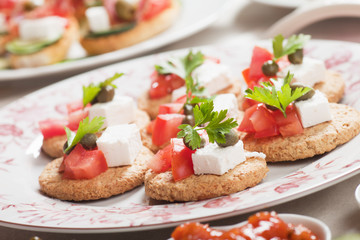 Canape with tomato and feta cheese