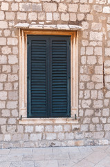 Framed ancient window with shutters