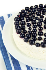 Cheesecake with fresh berries on white plate closeup
