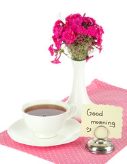 Beautiful bouquet of phlox with cup of tea isolated on white