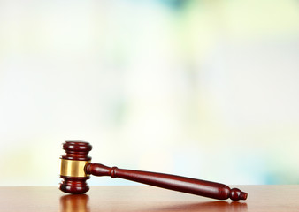 Judges gavel on wooden table on light background