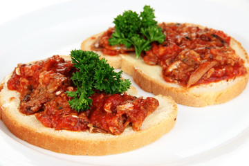Tasty sandwiches with sardines  and tomato sauce, close-up