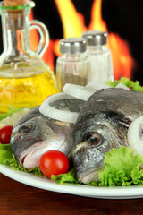 Dorado fish on table on fire background