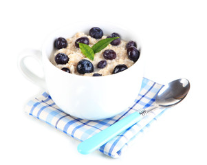 Oatmeal in cup with berries isolated on white