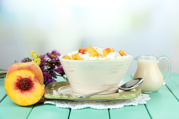 Sour cheese and pieces of fresh peach,on wooden table,