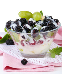 Fruit salad in glass bowl, isolated on white