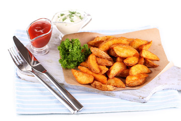 Home potatoes on tracing paper on wooden board isolated on