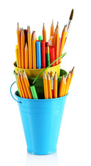 Colorful pencils and other art supplies in pails isolated