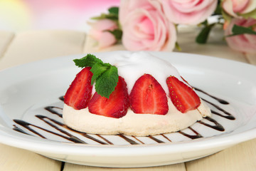 Tasty meringue cake with berries on table