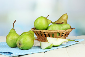 Pears in  wicker basket, on light background