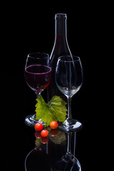 Red wine bottle, grapes and full glass