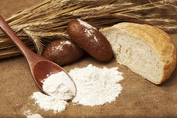 flour on a wooden spoon and bakery products