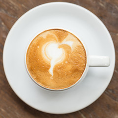 close up a cup of coffee on wooden table