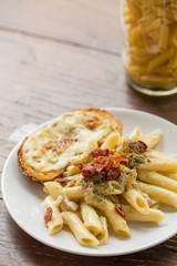 Penne Pasta with Ham and Cheese on wooden table