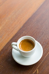 close up a cup of coffee on wooden table