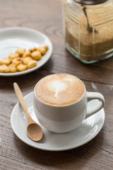 close up a cup of coffee on wooden table