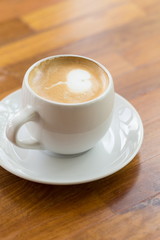 close up a cup of coffee on wooden table