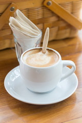 close up a cup of coffee on wooden table