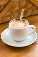 close up a cup of coffee on wooden table