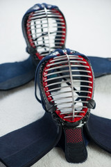 Vertical shot of two kendo helmets, close-up