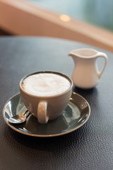close up a cup of coffee on black table