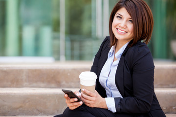 Cute businesswoman with cell phone